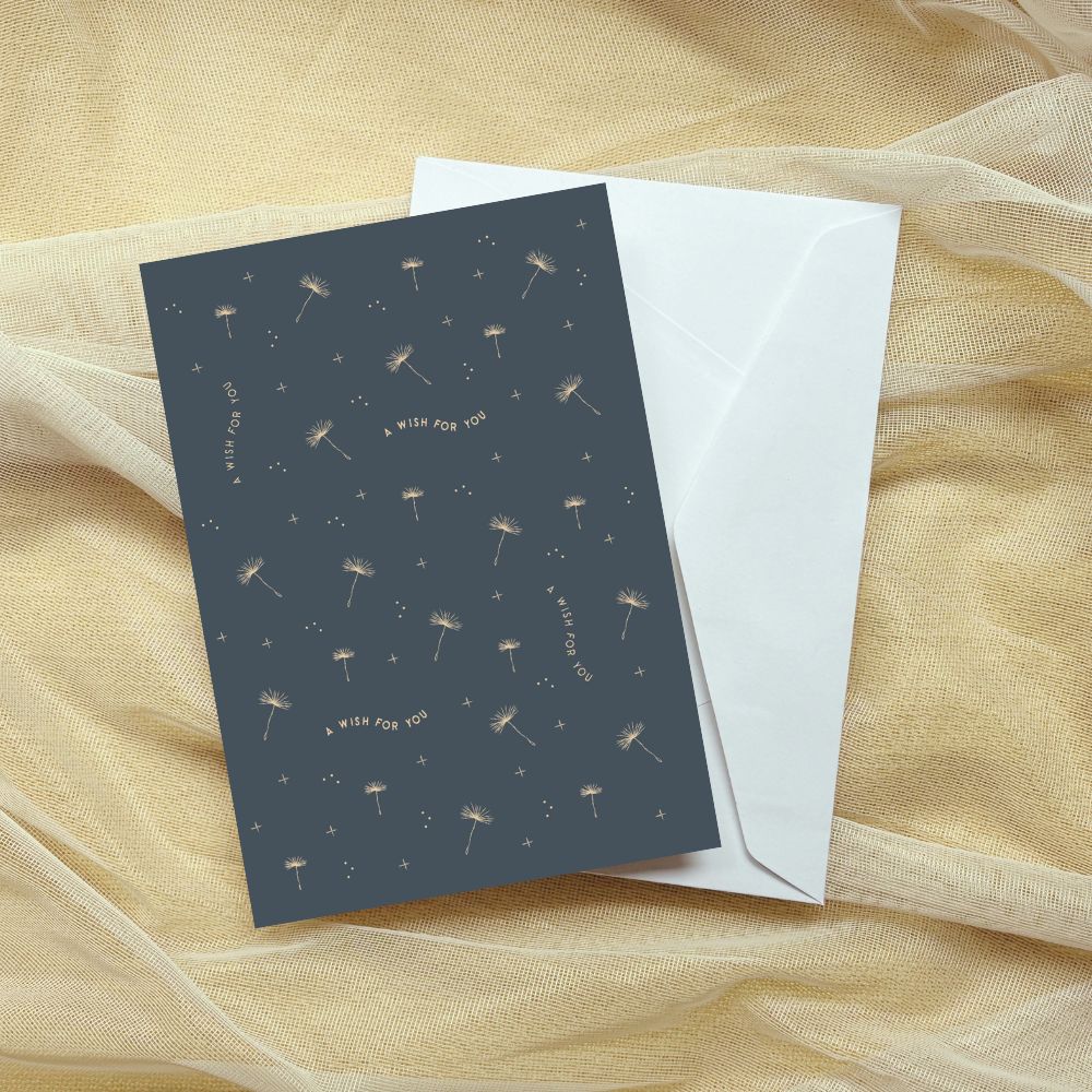 Greeting card with dandelion design and envelope on a sheer fabric background