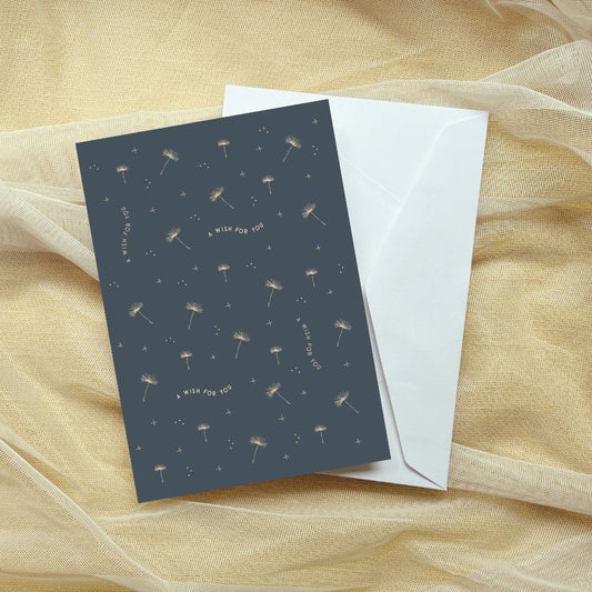 Greeting card with dandelion design and envelope on a sheer fabric background