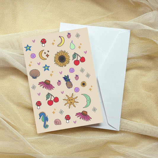 Greeting card with colorful illustrations on beige paper with a white envelope, on a sheer beige fabric background.